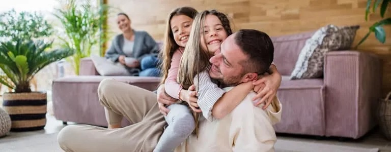 Boiler Repair & Service two happy sisters having fun with father web | River City Heating & Air Conditioning